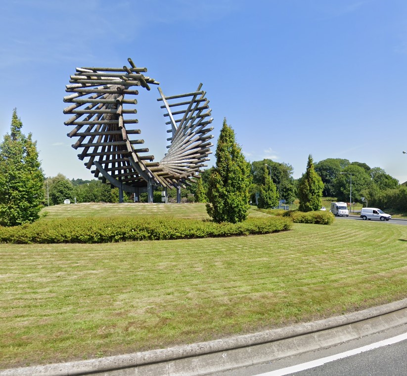 Image showcasing a typical roundabout planting scheme including a gateway sculpture.